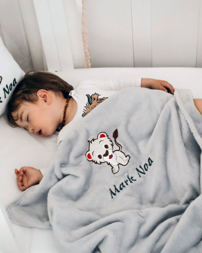 Cute boy in deep sleep covered with his personalized blanket