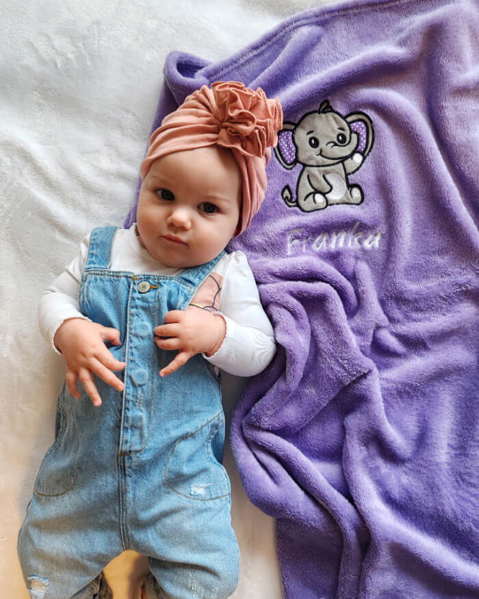 Cute stylish baby girl Franka enjoying a photosession with her personalized blanket